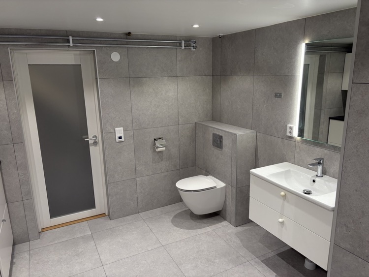 Vägghängd WC och spegel installerade efter kakelsättning